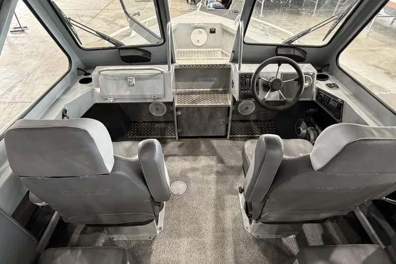 Slide: The Image of Interior of 2026 Hewescraft 190 Sea Runner ET boat, featuring dual seats and steering console. - 21