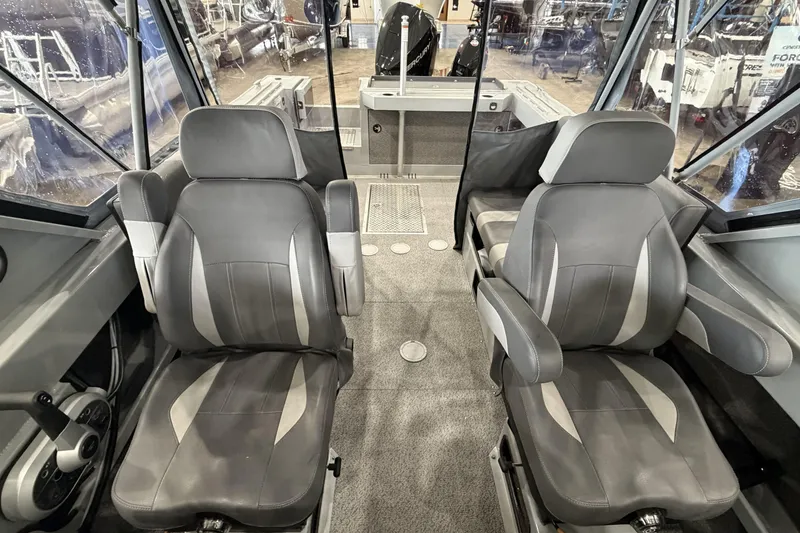 Slide: The Image of Interior of 2026 Hewescraft 190 Sea Runner ET with two gray captain's chairs. - 22