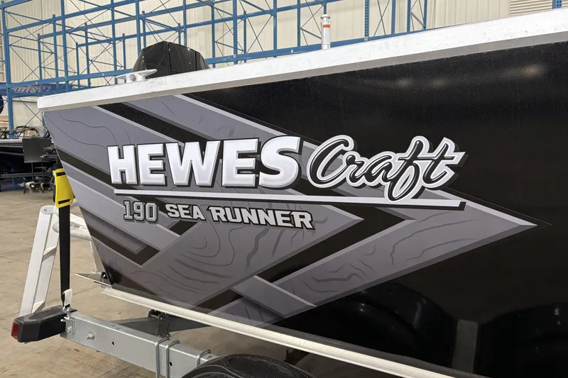 Slide: The Image of 2026 Hewescraft 190 Sea Runner ET boat in a warehouse setting. - 25