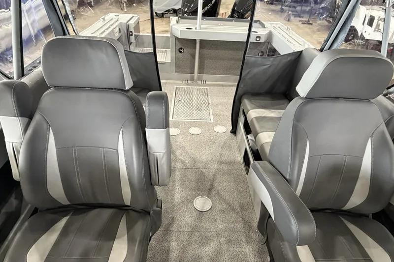 Slide: The Image of Interior of 2026 Hewescraft 190 Sea Runner ET with gray seating and carpeted floor. - 26