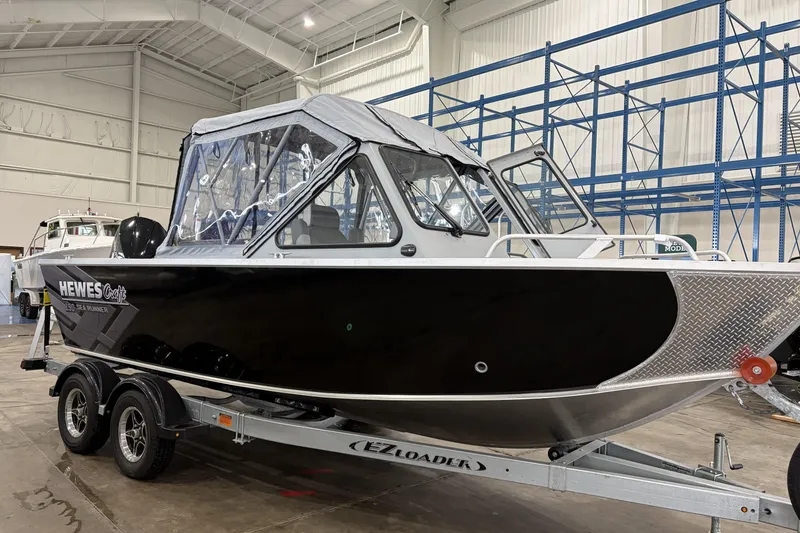 Slide: The Image of 2026 Hewescraft 190 Sea Runner ET boat on trailer in indoor storage facility. - 4