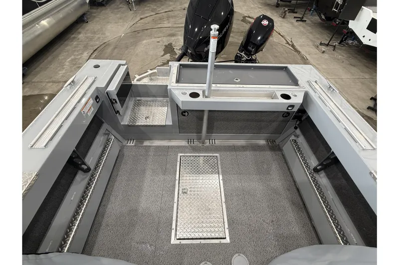 Slide: The Image of 2026 Hewescraft 190 Sea Runner ET boat interior with storage compartments and fishing rod holders. - 7