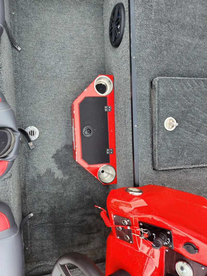 Slide: The Image of 2021 Caravelle Raptor 180 Bass boat interior with red accents and cup holders. - 13