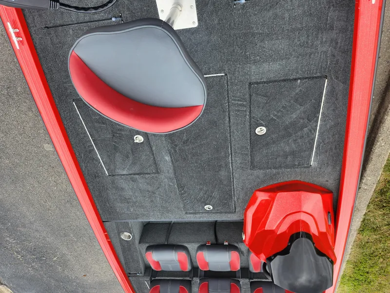Slide: The Image of 2021 Caravelle Raptor 180 Bass boat interior with red and black seating. - 18
