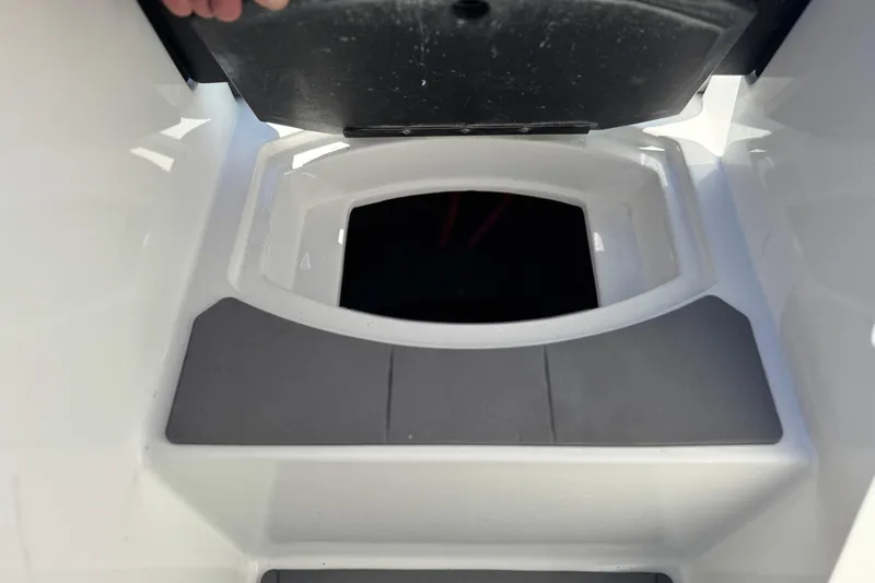 Slide: The Image of 2023 Axis T220 boat storage compartment with open lid, showcasing interior space. - 14