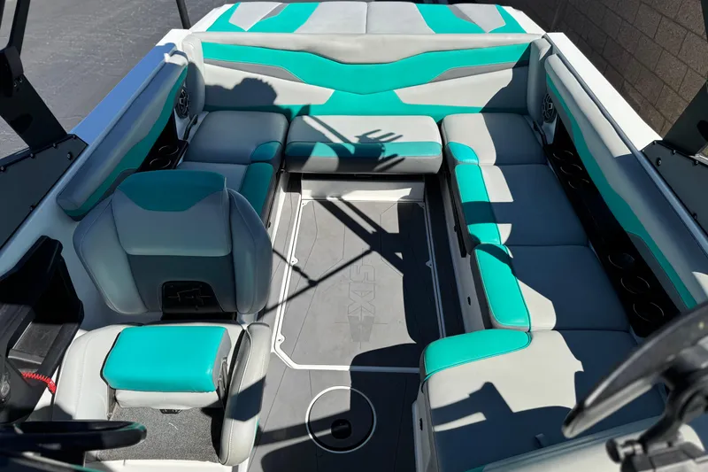Slide: The Image of 2023 Axis T220 boat interior with teal and gray seating arrangement. - 15