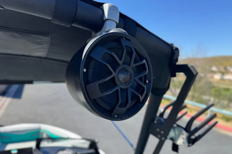 Slide: The Image of 2023 Axis T220 boat speaker mounted on a wakeboard tower under clear blue sky. - 18