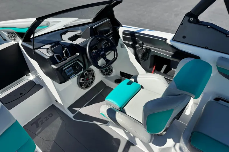 Slide: The Image of 2023 Axis T220 boat interior with modern dashboard and teal-accented seating. - 27