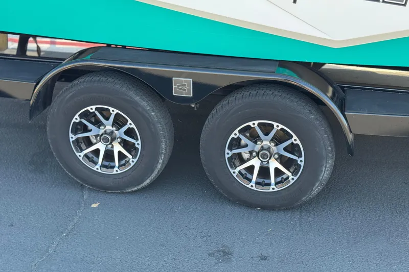 Slide: The Image of 2023 Axis T220 trailer wheels with stylish alloy rims on asphalt surface. - 34