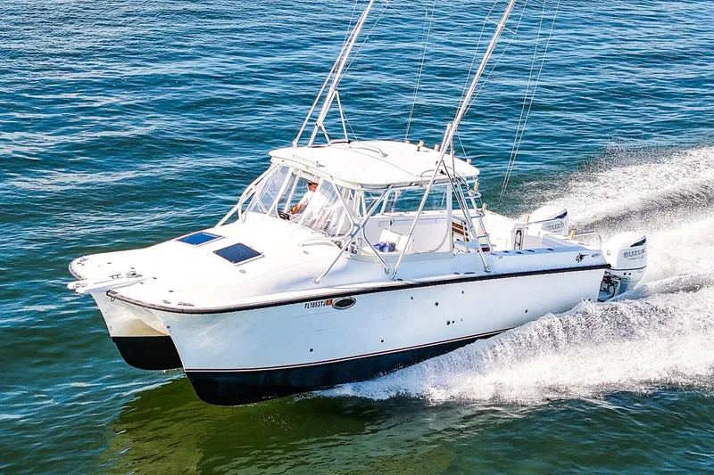 Slide: The Image of Powercat 30 Ope 2000 model cruising on open water, showcasing sleek design and performance. - 1