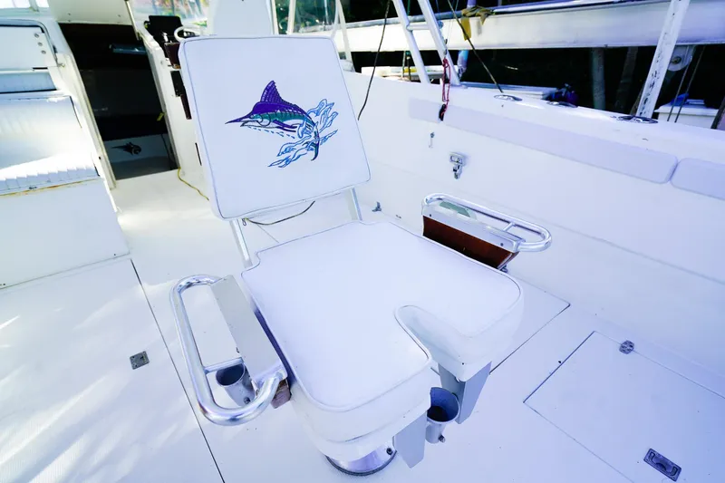 Slide: The Image of Powercat 30 Ope 2000 boat with marlin-embroidered fishing chair on deck. - 10