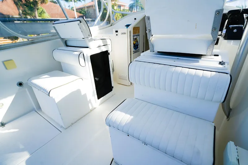 Slide: The Image of Interior of a 2000 Powercat 30 Ope boat with white seating and storage compartments. - 12
