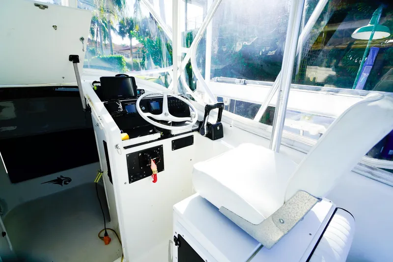 Slide: The Image of Powercat 30 Ope 2000 boat interior with steering wheel and control panel. - 13