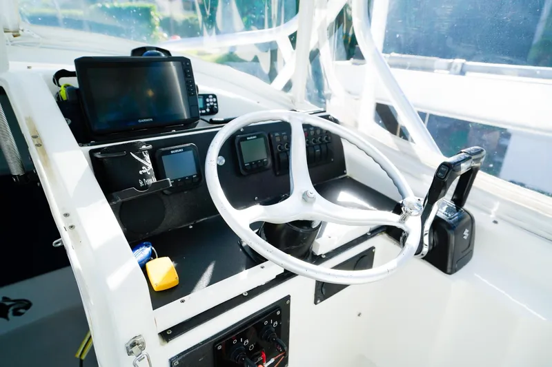 Slide: The Image of Helm of 2000 Powercat 30 Ope boat with steering wheel and navigation equipment. - 15
