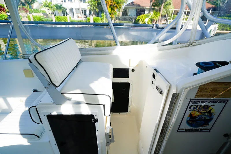 Slide: The Image of Powercat 30 Ope 2000 boat interior with white seating and storage compartments. - 16