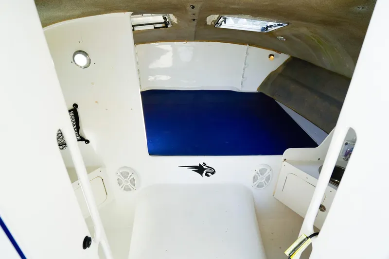 Slide: The Image of Interior of 2000 Powercat 30 Ope boat with blue seating and white walls. - 17