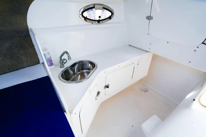 Slide: The Image of Interior of 2000 Powercat 30 Ope boat with sink and storage compartment. - 19