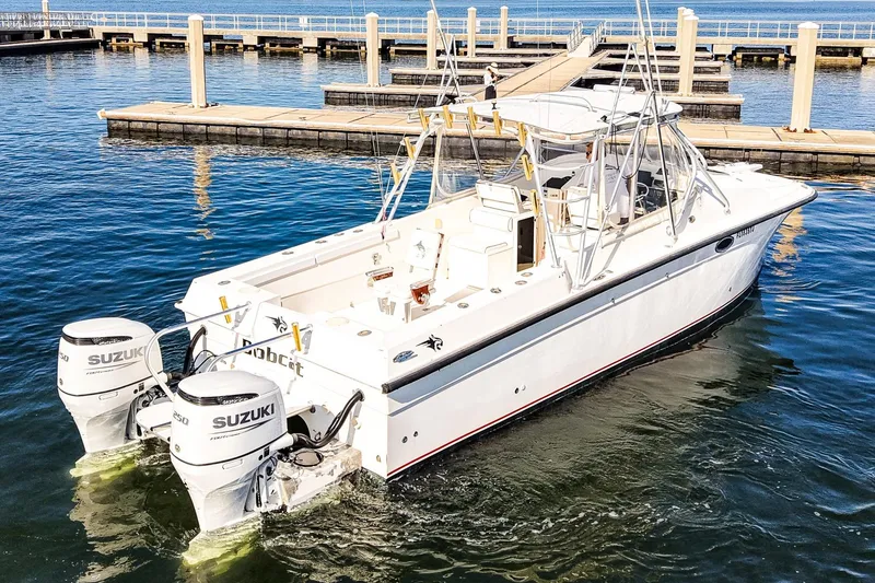 Slide: The Image of Powercat 30 Ope 2000 boat with twin Suzuki engines docked in marina. - 27