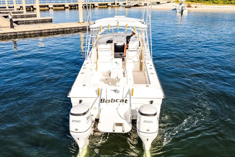 Slide: The Image of Powercat 30 Ope 2000 boat with dual engines docked in a marina. - 29