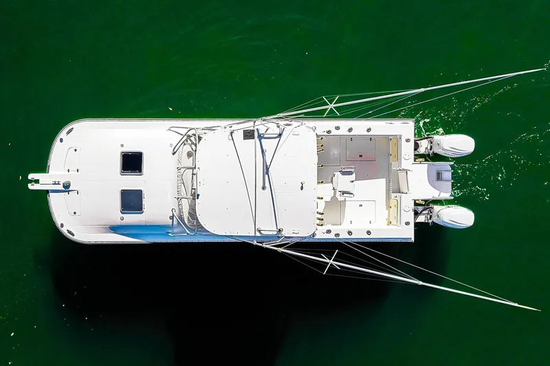 Slide: The Image of Overhead view of 2000 Powercat 30 OPE boat on green water. - 4