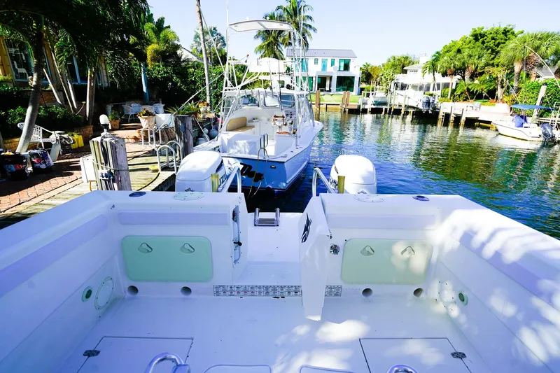 Slide: The Image of Powercat 30 Ope 2000 model docked in a scenic marina with lush greenery. - 7