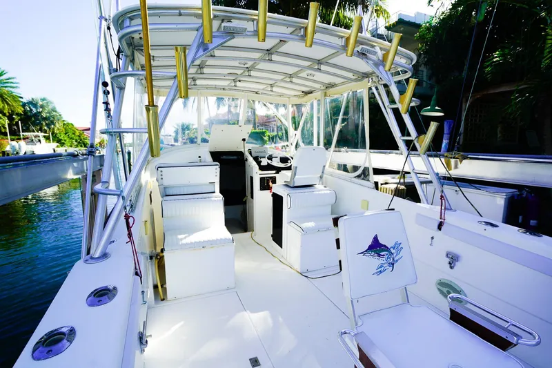 Slide: The Image of Powercat 30 Ope 2000 model boat interior with fishing rod holders and seating. - 8