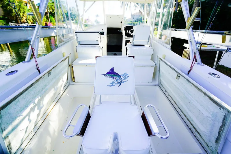 Slide: The Image of Powercat 30 Ope 2000 boat interior with white seating and fishing rod holders. - 9