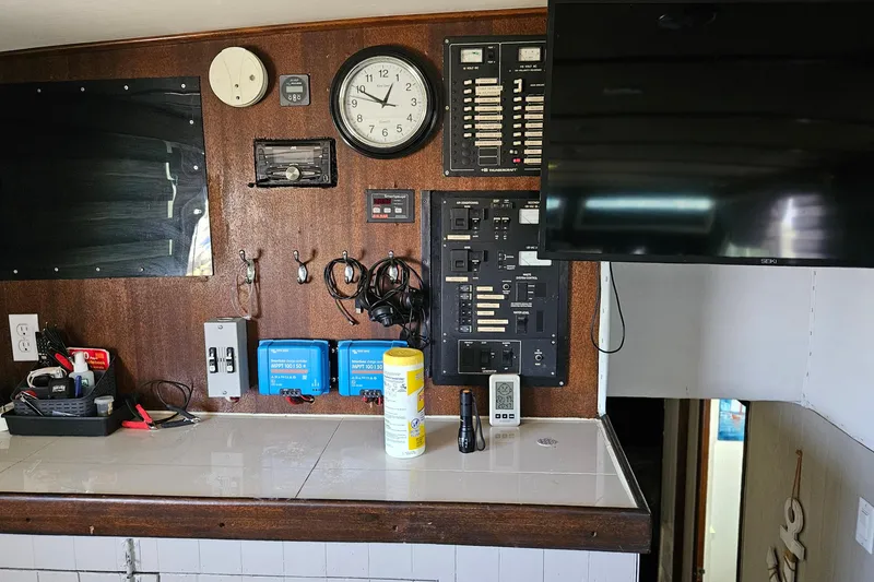 Slide: The Image of Interior of 1967 Hatteras 44 Tri Cabin with control panels and mounted TV. - 14