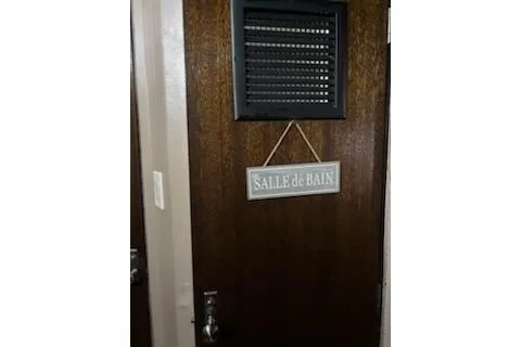 Slide: The Image of Wooden door with "Salle de Bain" sign on a 1967 Hatteras 44 Tri Cabin yacht. - 21
