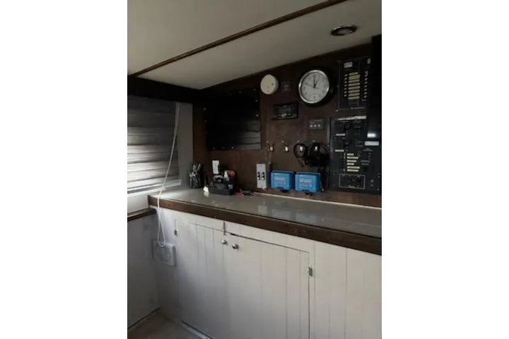 Slide: The Image of 1967 Hatteras 44 Tri Cabin interior with control panel and storage cabinets. - 23