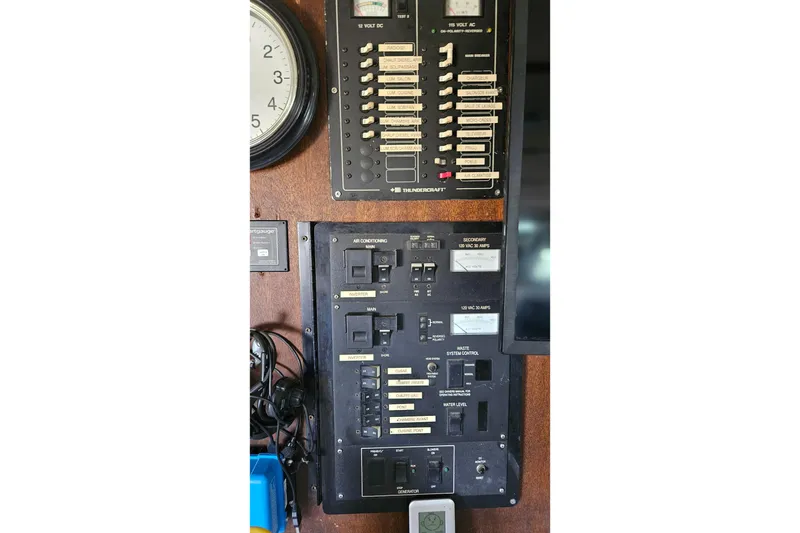 Slide: The Image of Electrical control panels on a 1967 Hatteras boat, featuring various switches and gauges. - 24