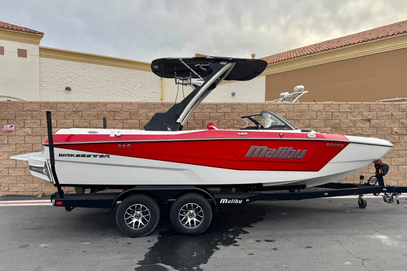 The Image of 2023 Malibu Wakesetter 21 LX boat on trailer, red and white design. - 0