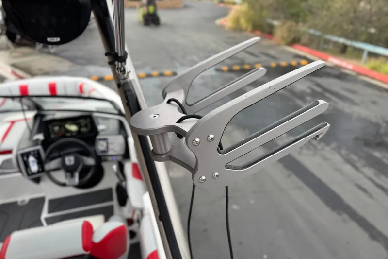 Slide: The Image of 2023 Malibu Wakesetter 21 LX boat interior with wakeboard rack and dashboard view. - 12