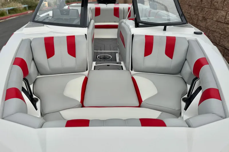 Slide: The Image of 2023 Malibu Wakesetter 21 LX interior with red and gray seating. - 13