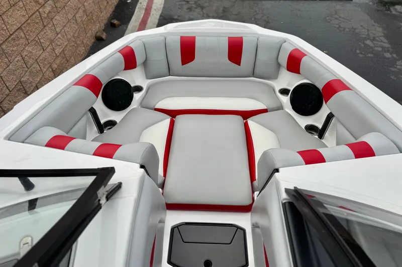 Slide: The Image of 2023 Malibu Wakesetter 21 LX boat interior with red and gray seating. - 14