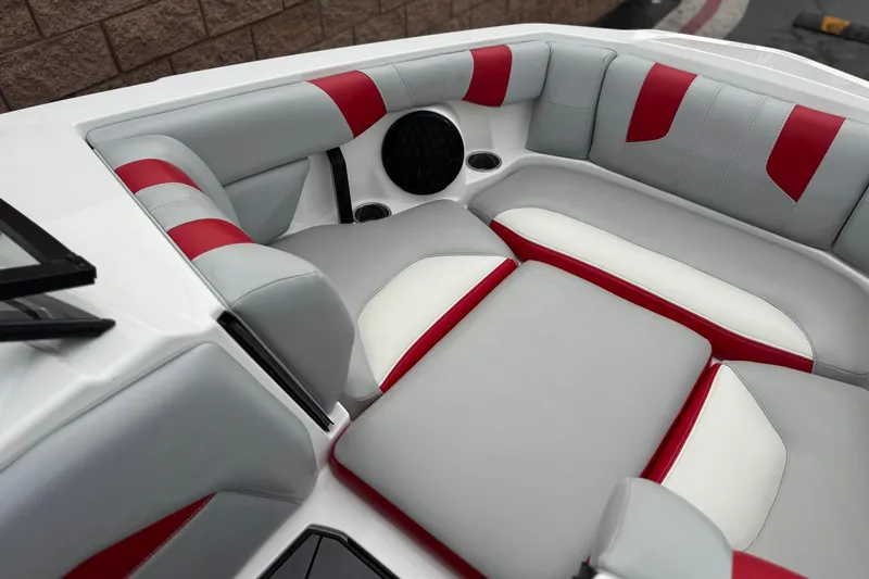 Slide: The Image of 2023 Malibu Wakesetter 21 LX interior with red and gray seating. - 15