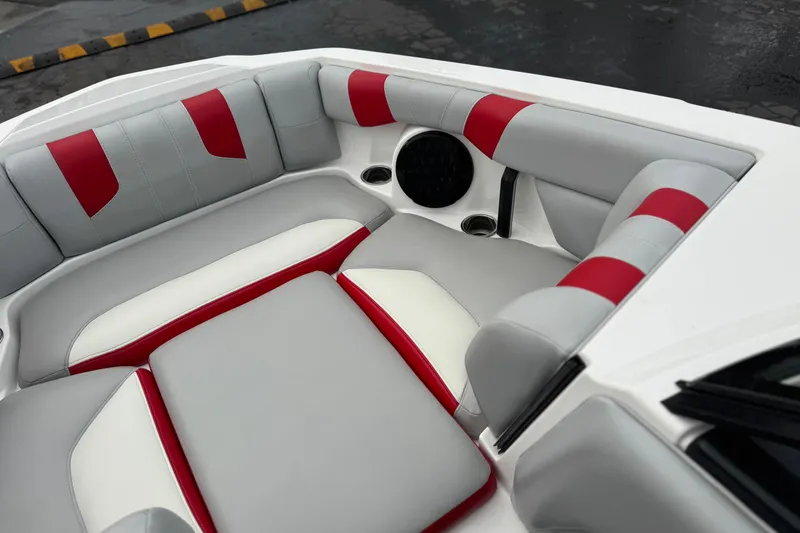 Slide: The Image of 2023 Malibu Wakesetter 21 LX boat interior with red and gray seating. - 16