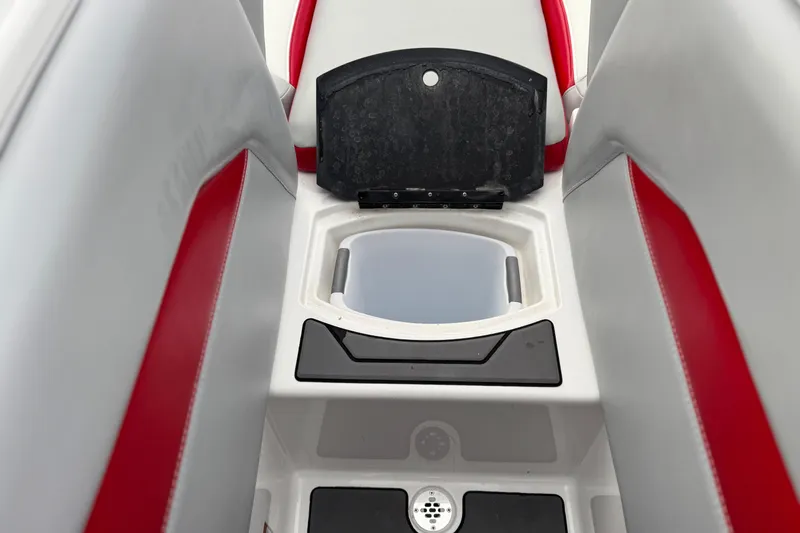 Slide: The Image of 2023 Malibu Wakesetter 21 LX interior storage compartment with red and gray seating. - 17