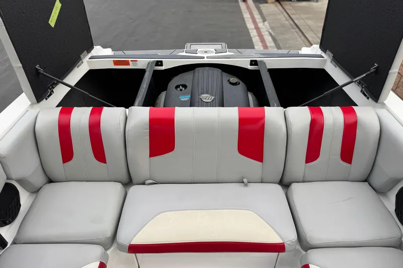 Slide: The Image of 2023 Malibu Wakesetter 21 LX boat interior with red and gray seating. - 21