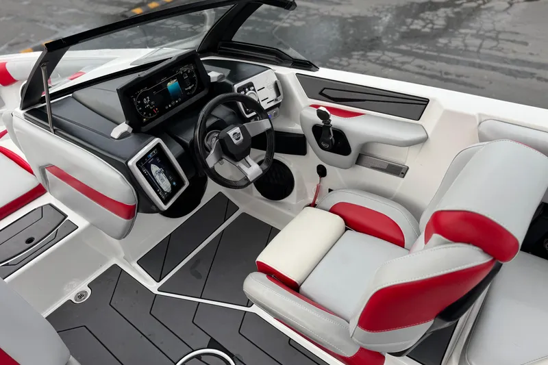 Slide: The Image of 2023 Malibu Wakesetter 21 LX boat interior with modern dashboard and red-accented seating. - 27