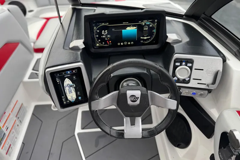 Slide: The Image of 2023 Malibu Wakesetter 21 LX dashboard with advanced digital controls and steering wheel. - 28