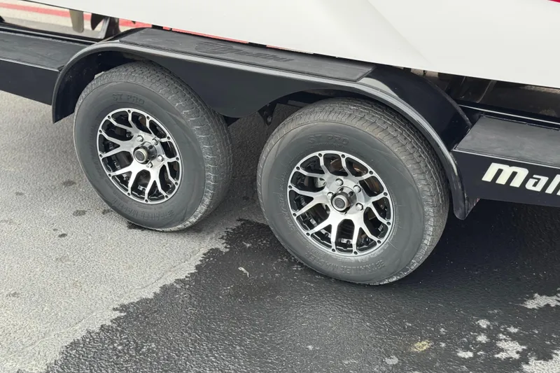 Slide: The Image of 2023 Malibu Wakesetter 21 LX trailer with dual wheels on a wet surface. - 35