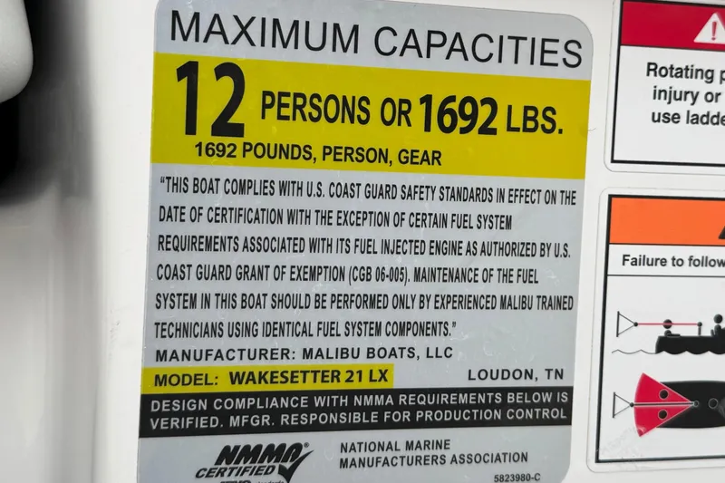 Slide: The Image of 2023 Malibu Wakesetter 21 LX capacity label: 12 persons or 1692 lbs, safety compliance. - 37