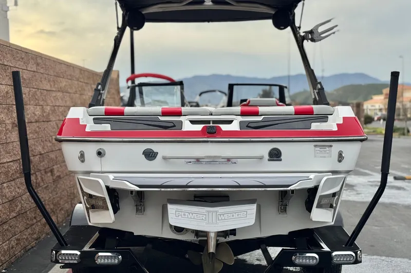 Slide: The Image of 2023 Malibu Wakesetter 21 LX boat rear view with red and white accents. - 4