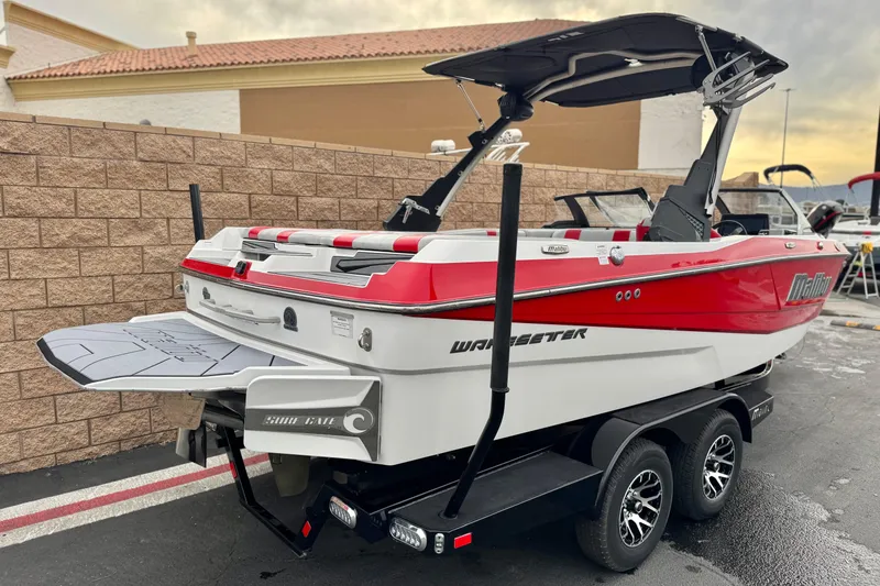 Slide: The Image of 2023 Malibu Wakesetter 21 LX boat on trailer, red and white design, rear view. - 5