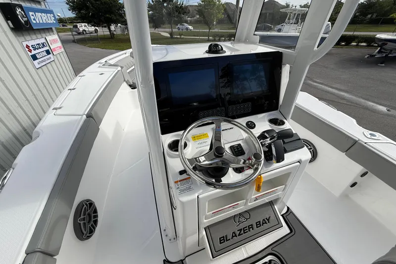 Slide: The Image of 2026 Blazer Bay Makaira 2600 boat cockpit with steering wheel and dual screens. - 14