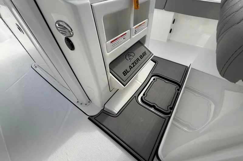 Slide: The Image of 2026 Blazer Bay Makaira 2600 interior detail with branded flooring and storage compartments. - 15
