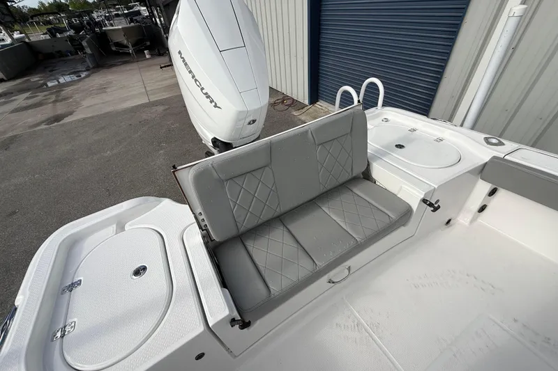 Slide: The Image of 2026 Blazer Bay Makaira 2600 boat interior with Mercury engine and cushioned seating. - 18