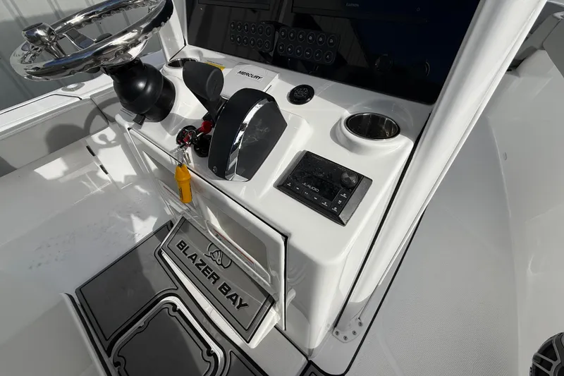 Slide: The Image of 2026 Blazer Bay Makaira 2600 boat console with steering wheel and controls. - 28
