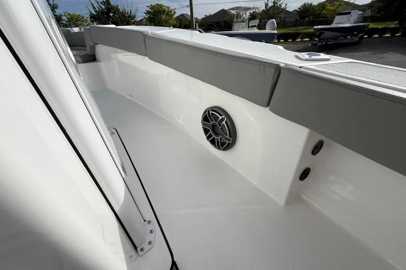 Slide: The Image of 2026 Blazer Bay Makaira 2600 boat interior with cushioned seating and speaker. - 29